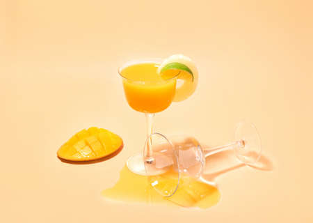 Glass of tasty mango margarita on color backgroundの写真素材