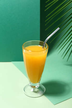 Glass of tasty mango margarita on color background