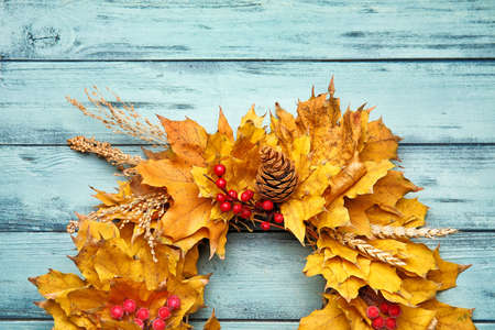 Beautiful autumn wreath on color wooden backgroundの写真素材
