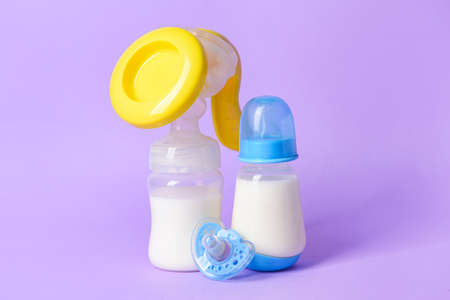 Breast pump and baby accessories on color backgroundの写真素材