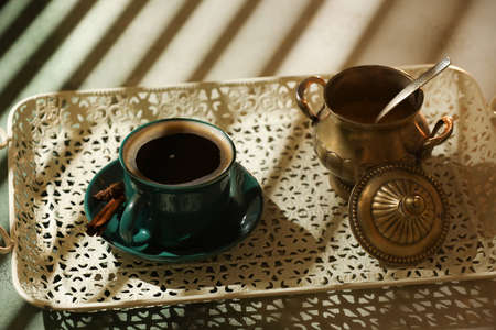 Cup of hot coffee and bowl with sugar on light backgroundの写真素材