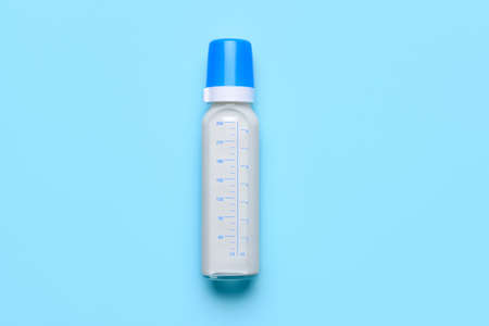 Bottle of milk for baby on color backgroundの写真素材