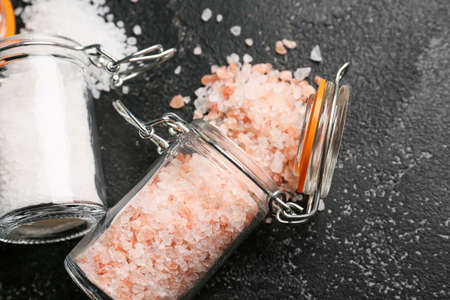 Jars with different salt on dark backgroundの写真素材