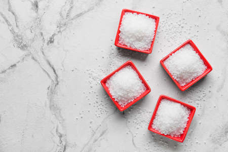 Bowls with salt on white background