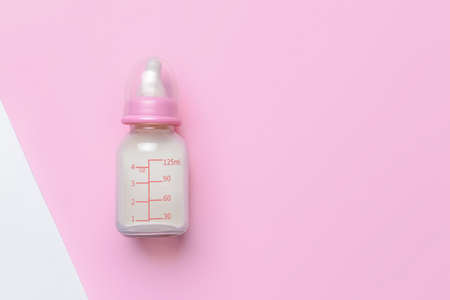 Bottle of milk for baby on color backgroundの写真素材