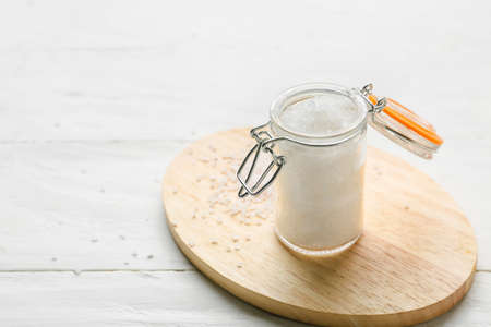 Jar with salt on white wooden backgroundの写真素材