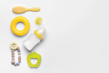 Bottle of milk for baby and accessories on white background