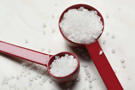 Measuring scoops with salt on white backgroundの写真素材