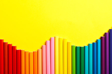 Composition with colorful pencils on color background