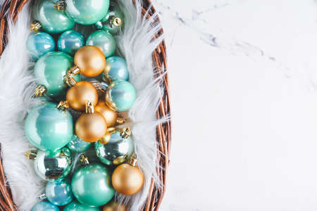 Beautiful Christmas balls in basket on light backgroundの写真素材