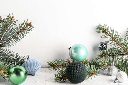Beautiful Christmas balls and fir branches on tableの写真素材