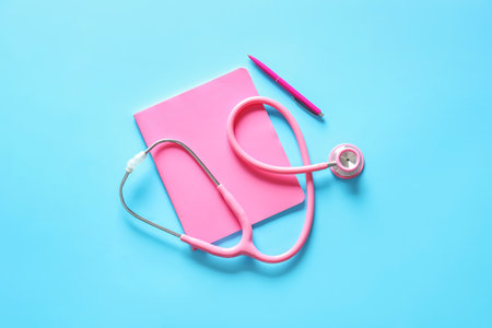 Stethoscope, notebook and pen on color backgroundの写真素材
