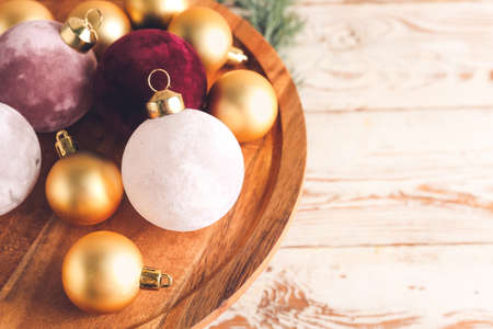 Beautiful Christmas balls on wooden stand, closeupの写真素材