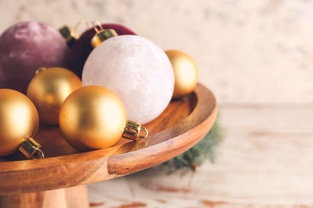 Beautiful Christmas balls on wooden stand, closeupの写真素材