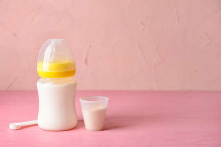 Bottle of baby milk formula on tableの写真素材
