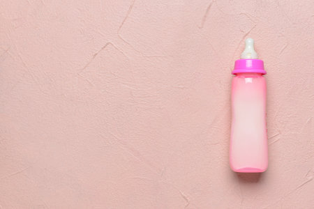 Bottle of milk for baby on color backgroundの写真素材