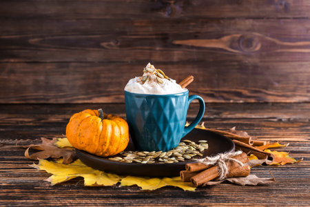 Cup of pumpkin cappuccino on tableの写真素材