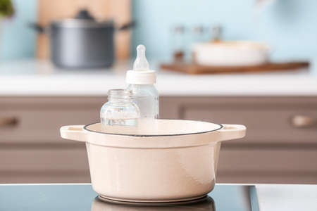 Cleaning of baby bottles in kitchenの写真素材
