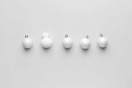 Christmas balls and makeup sponge on white backgroundの写真素材