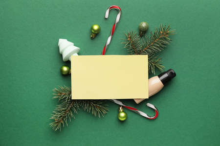 Christmas composition with cosmetics and blank card on color backgroundの写真素材