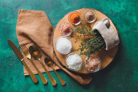 Composition with different salt and thyme on color background