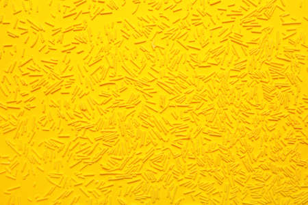Sweet sprinkles on color backgroundの写真素材