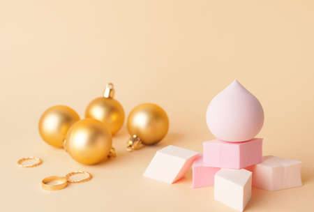 Christmas balls and makeup sponges on color backgroundの写真素材