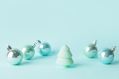 Christmas balls and makeup sponge on color backgroundの写真素材