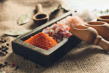 Board with different salt on table, closeupの写真素材