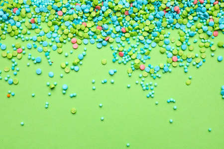 Sweet sprinkles on color backgroundの写真素材