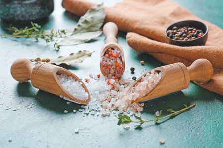 Composition with different salt and thyme on color background, closeup