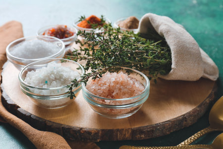 Composition with different salt and thyme on color background, closeupの写真素材