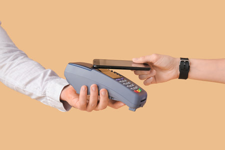 Buyer paying for purchase via terminal on color background