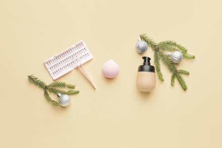 Christmas composition with cosmetics and fake eyelashes on color backgroundの写真素材