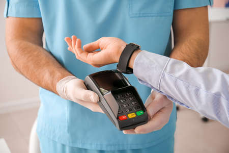 Patient paying for consultation in clinic via terminal