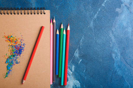Pencils and notebook on color backgroundの写真素材