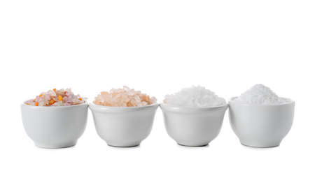 Bowls with different salt on white backgroundの写真素材