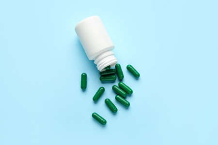 Bottle with pills on color backgroundの写真素材