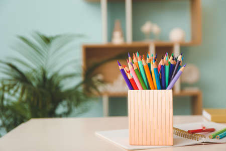 Holder with colorful pencils on tableの写真素材