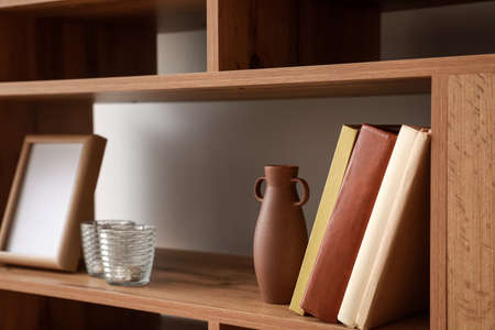 Shelving unit with books and decor in interior of roomの写真素材