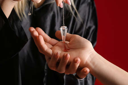 Fortune teller reading client's future against color background, closeupの写真素材