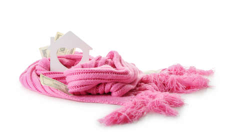Figure of house, money and warm scarf on white background. Concept of heating seasonの写真素材