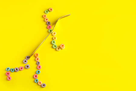 Creative composition with cereal rings and fork on color backgroundの写真素材