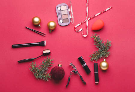 Frame made of cosmetics with Christmas decor on color backgroundの写真素材
