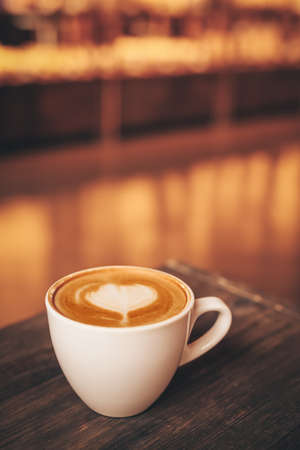 Cup of coffee with latte art on tableの写真素材