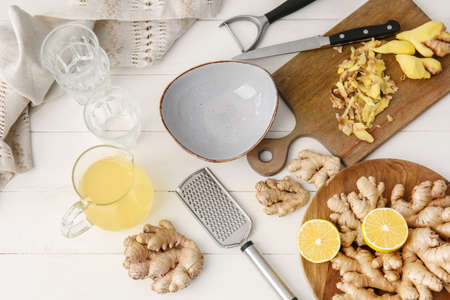 Composition with healthy ginger juice on white wooden backgroundの写真素材