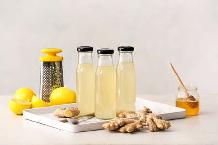 Composition with healthy ginger juice on light backgroundの写真素材