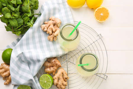 Composition with healthy ginger juice on white wooden backgroundの写真素材