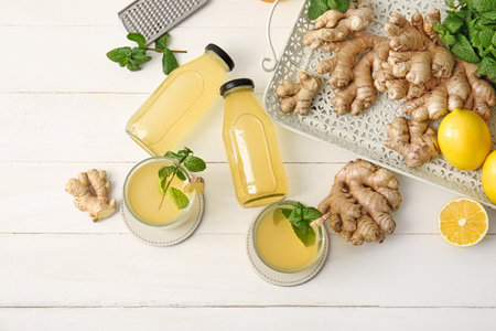 Composition with healthy ginger juice on white wooden backgroundの写真素材