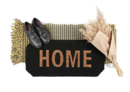 Doormat with shoes and plaid on white backgroundの写真素材